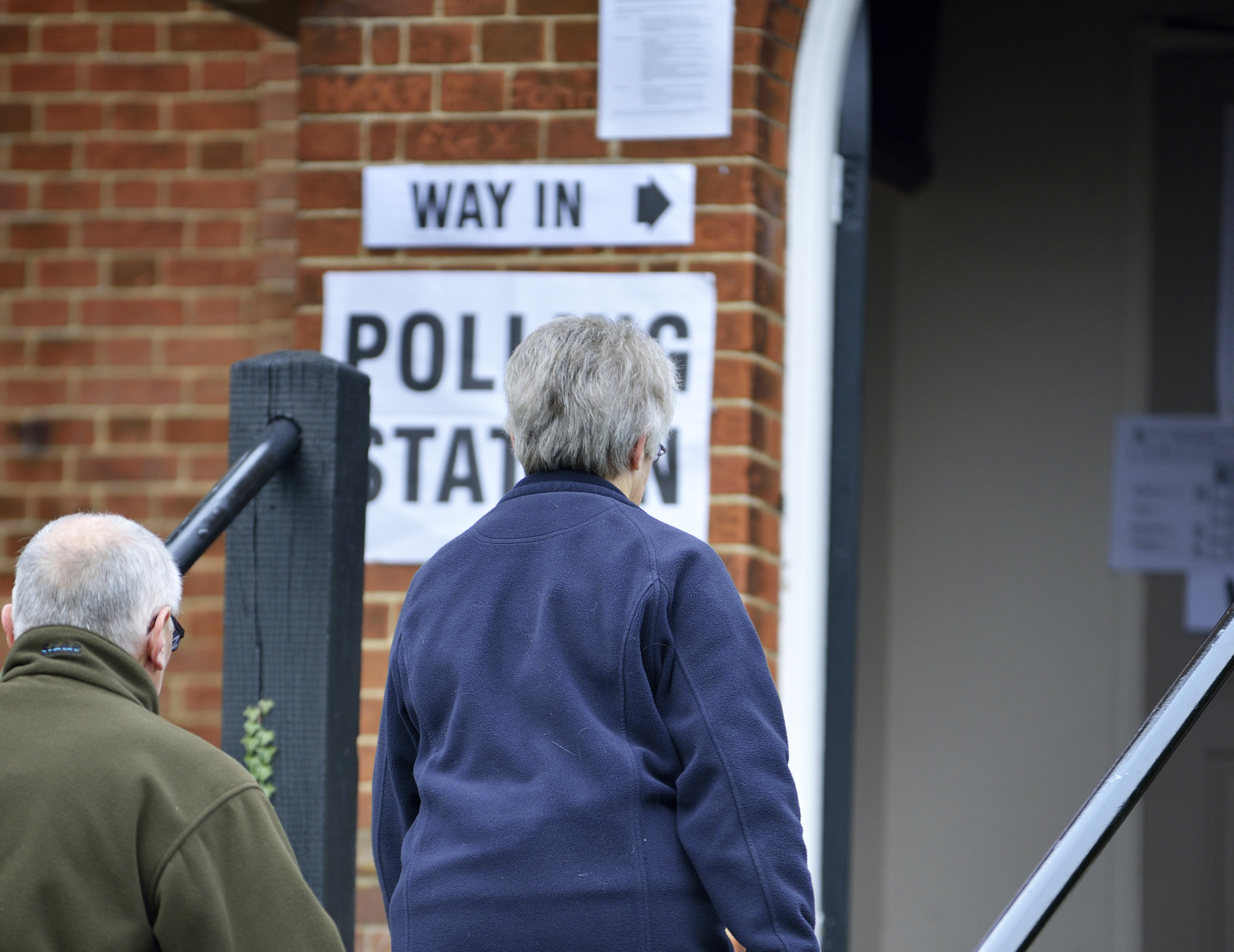 people entering a polling station